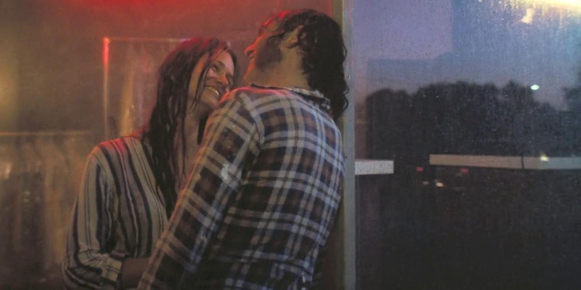 Shashta and Doc smiling in the rain in 'Inherent Vice'