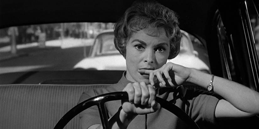 Marion Crane driving and looking pensive in Psycho.