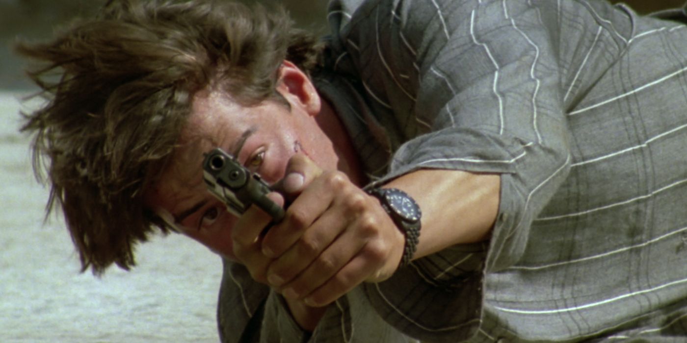 Keanu Reeves Lying on ground pointing a gun in Point Break