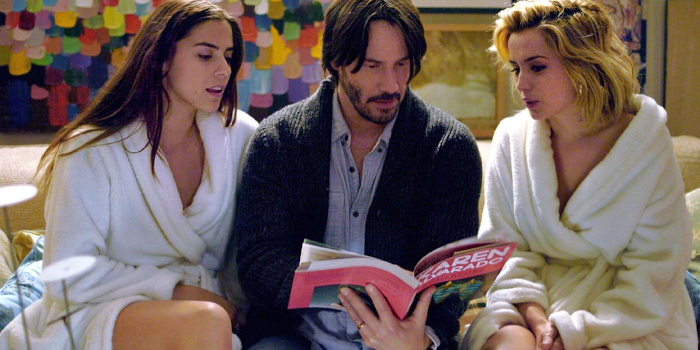 Lorenza Izzo, Keanu Reeves, and Ana de Armas reading a book in Knock Knock