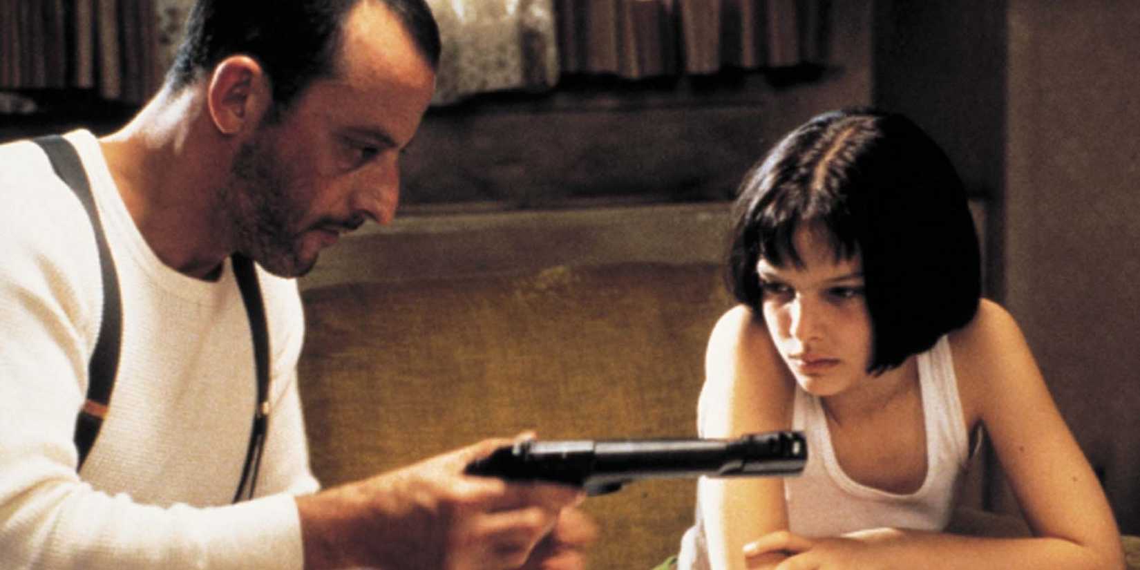 Léon (Jean Reno) teaches Mathilda (Natalie Portman) to use a gun in Léon: The Professional (1994)