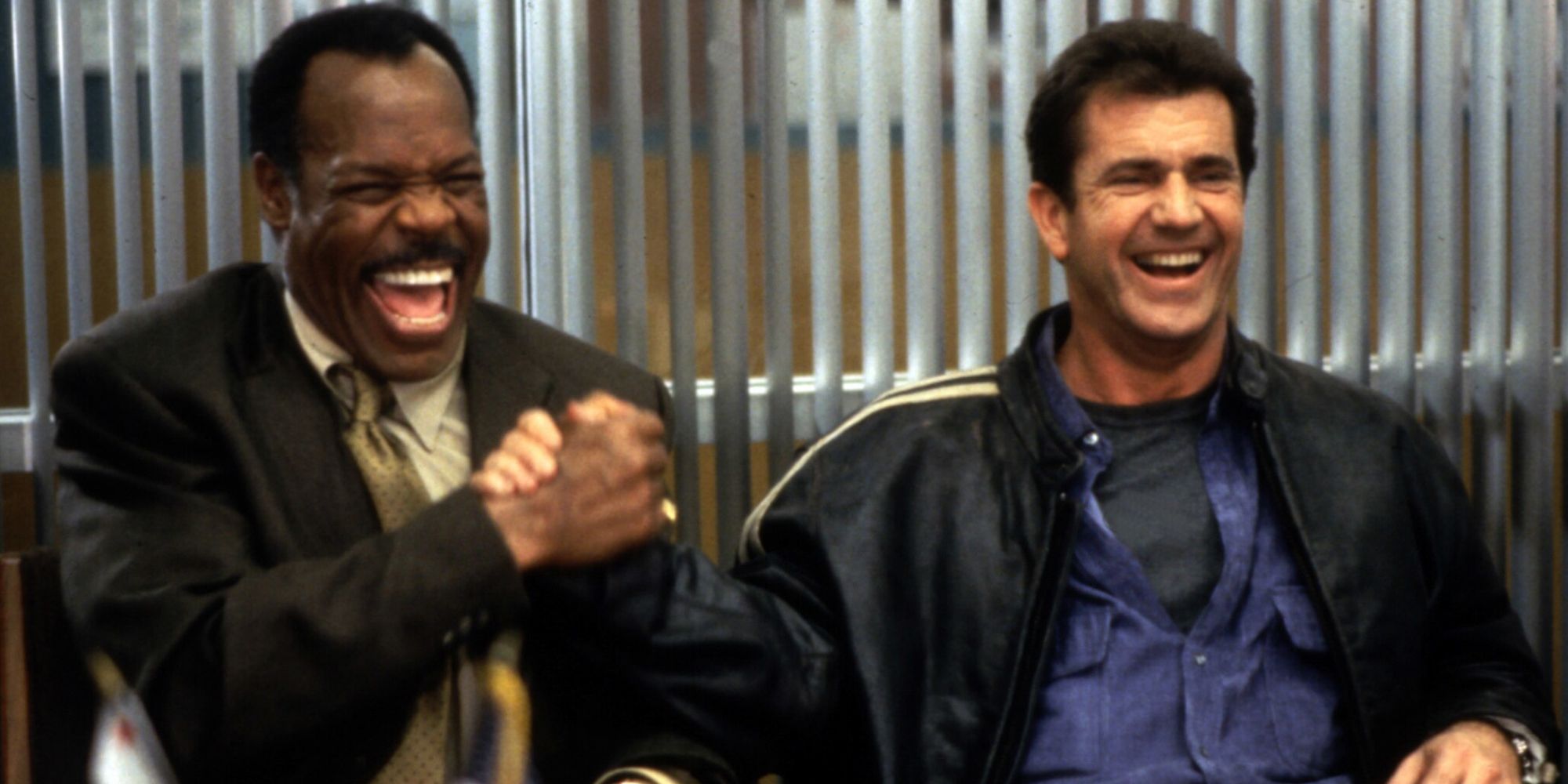 Donald Glover and Mel Gibson laughing and shaking hands in Lethal Weapon 4