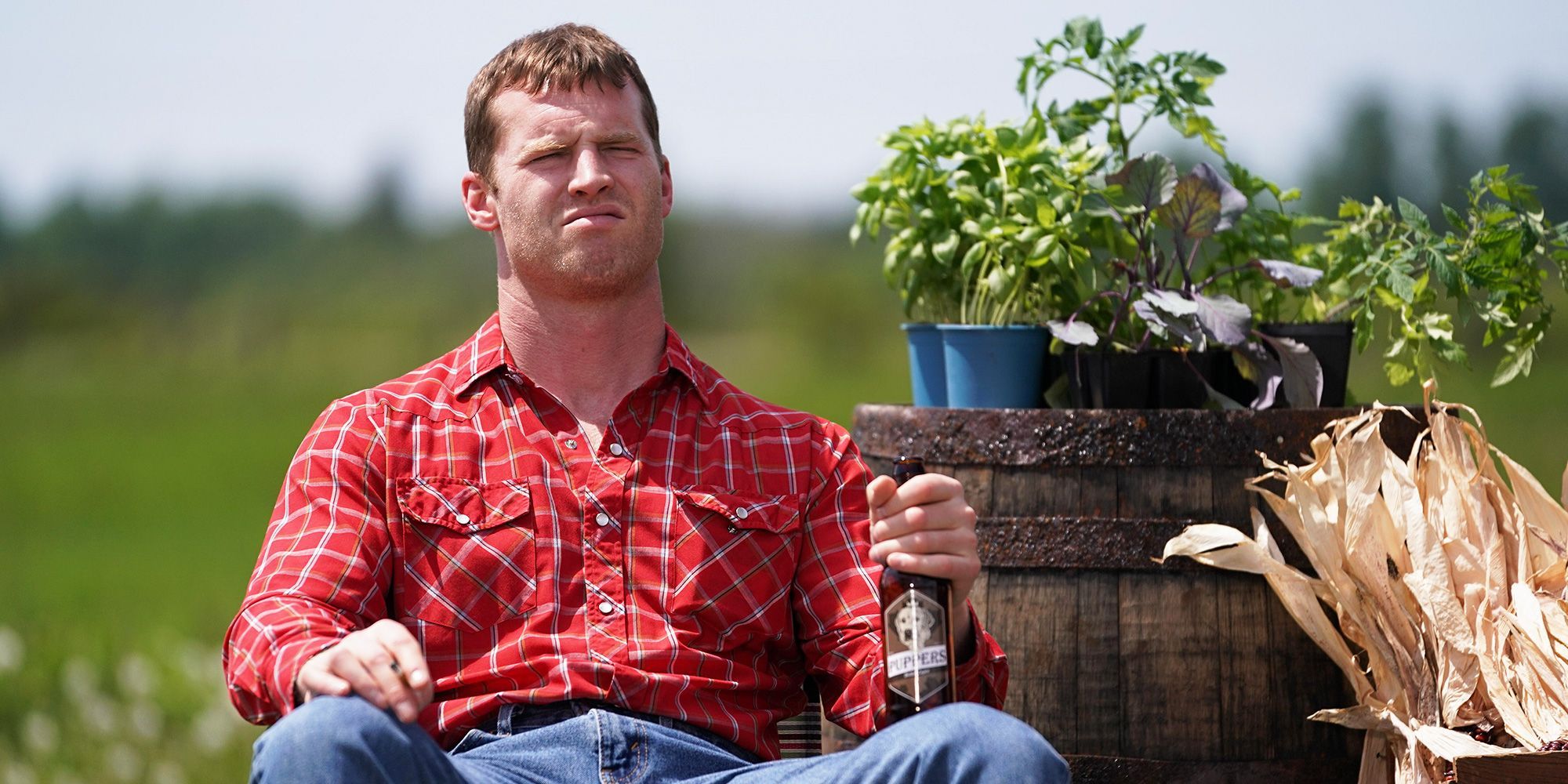 Jared Keeso sitting at Letterkenny drinking a beer