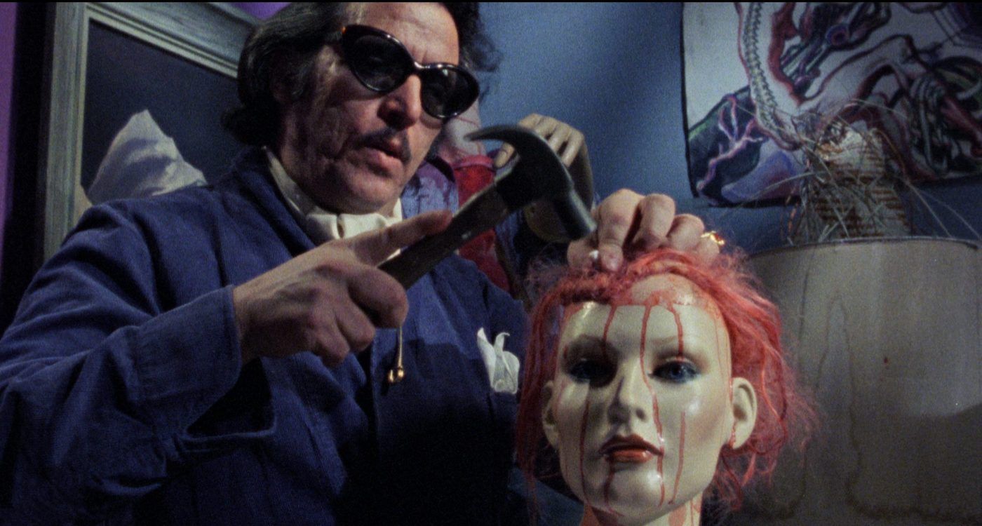 Man hammering a mannequin head in Maniac (1980)