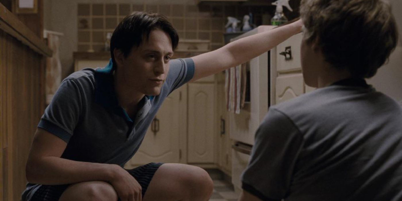 Kieran Culkin crouching down in a kitchen as Wallace Wells in Scott Pilgrim vs. the World 