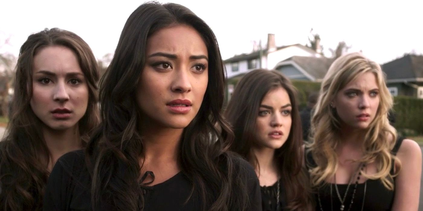 Quatre jeunes femmes de Pretty Little Liars, toutes vêtues de noir, ont l'air choquées par quelque chose.