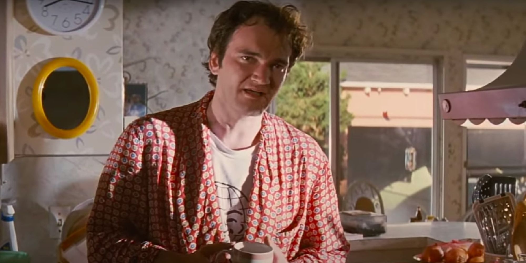 Quentin Tarantino as Jimmy, holding a mug in Pulp Fiction