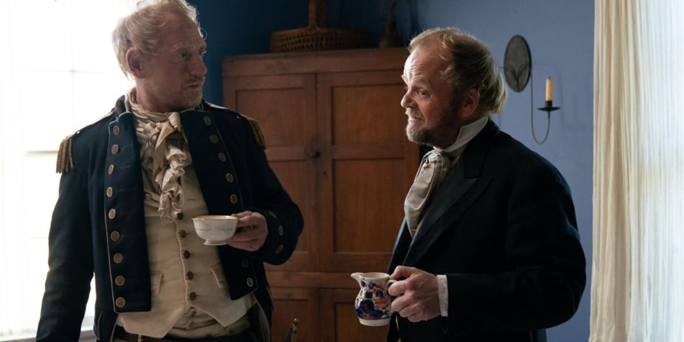 The Captain (Scott Shepherd) and the Chief Factor (Toby Jones) talking over a cup of tea in First Cow