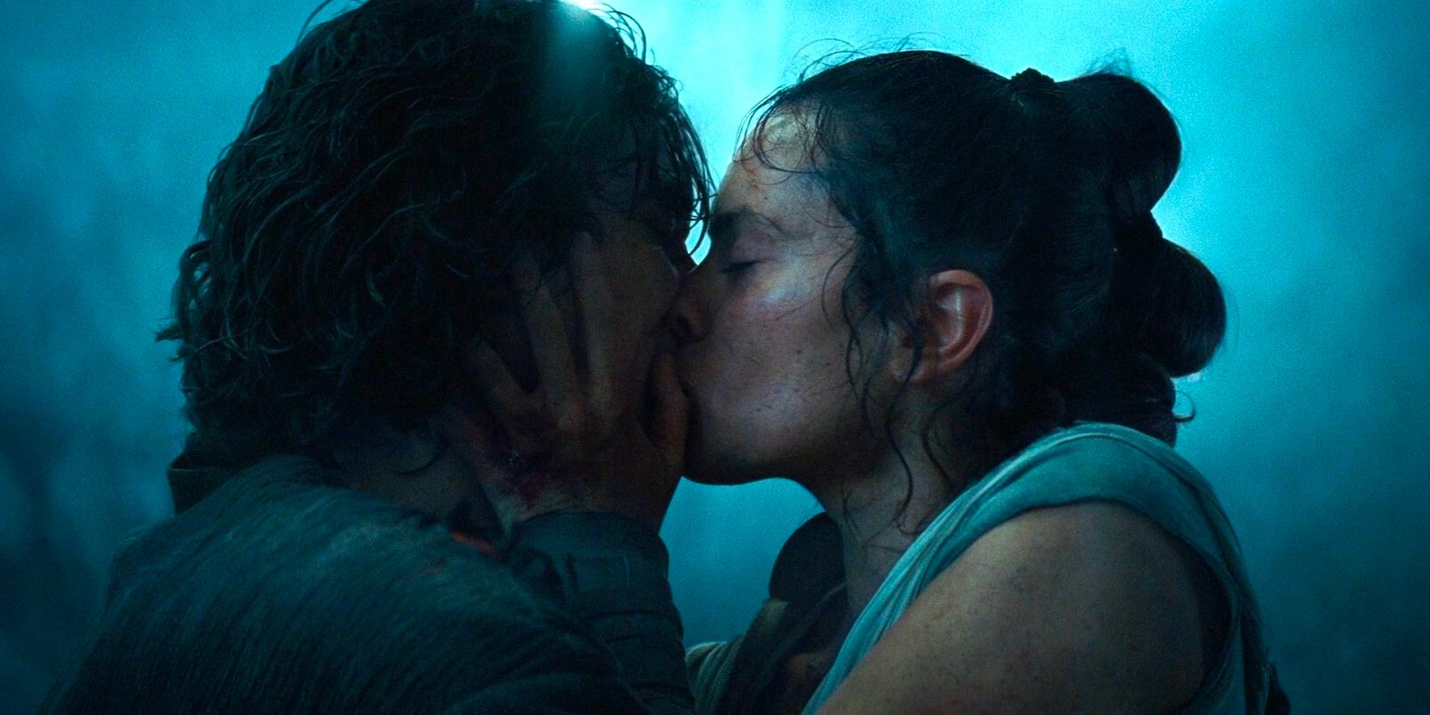 Rey romantically kisses Kylo Ren. 