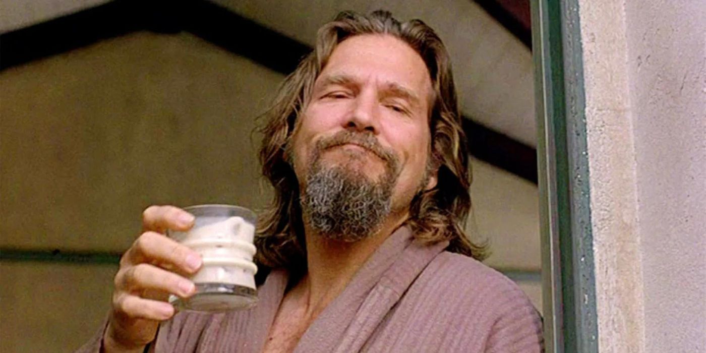 The Dude wearing a bathrobe and holding up a White Russian in The Big Lebowski