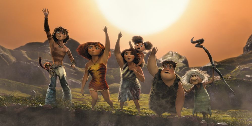 The Croods family standing before the sun