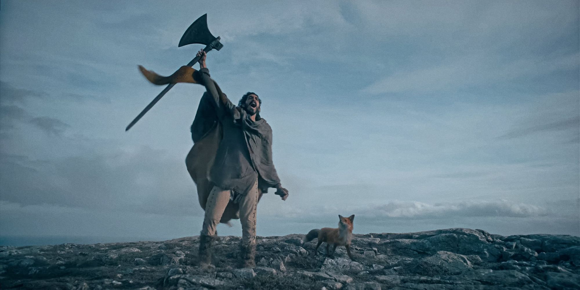 Sir Gawain lifting his axe to the sky in The Green Knight (2021) 