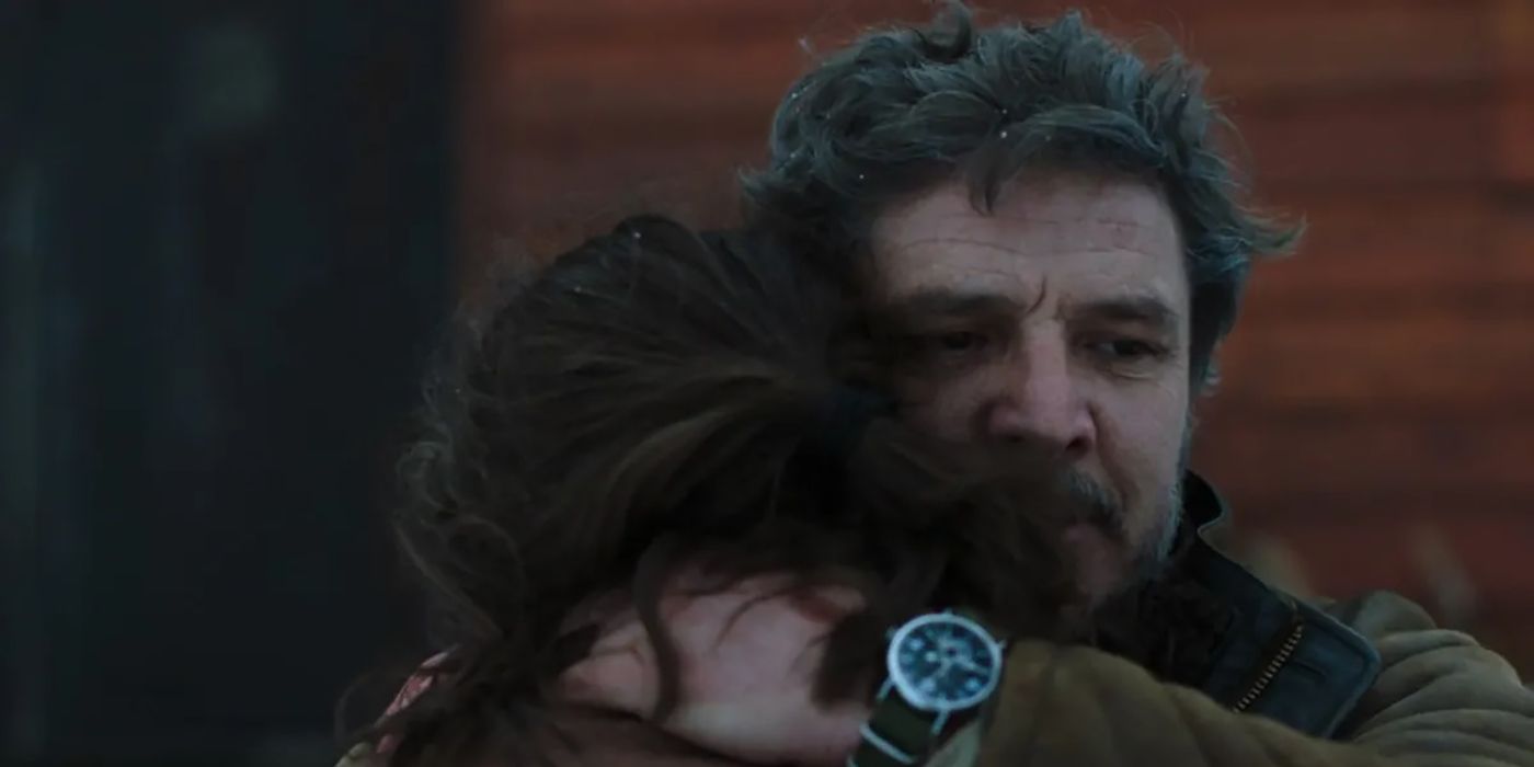 Joel embracing Ellie in a tight hug in a scene from The Last of Us.