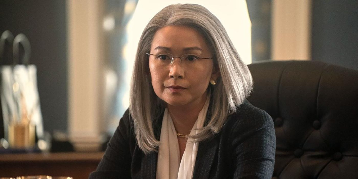 Diane from The Night Agent sitting at her desk, looking spaced out. 