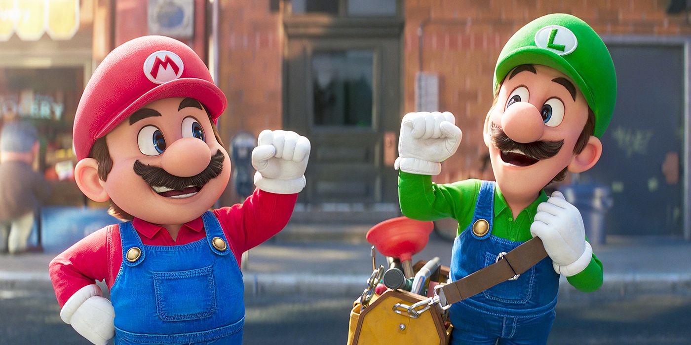 Mario and Luigi smiling with their fists raised in the air in The Super Mario Bros. Movie