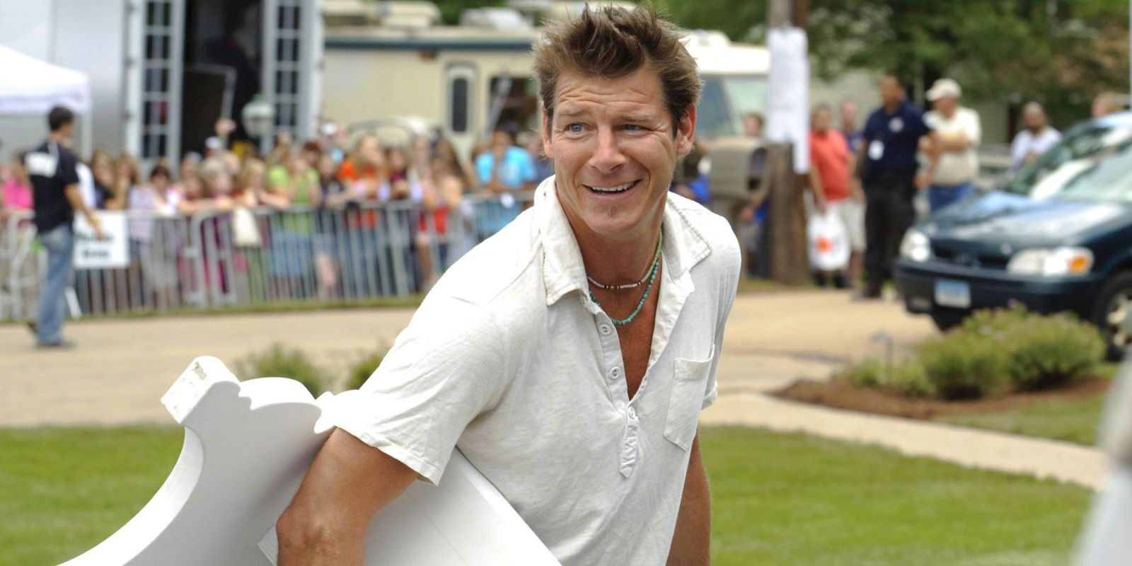 Ty Pennington holding furniture on Extreme Makeover Home Edition