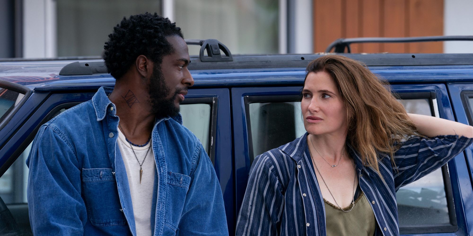 Quentin Plair as Danny and Kathryn Hahn as Clare leaning against car in Tiny Beautiful Things