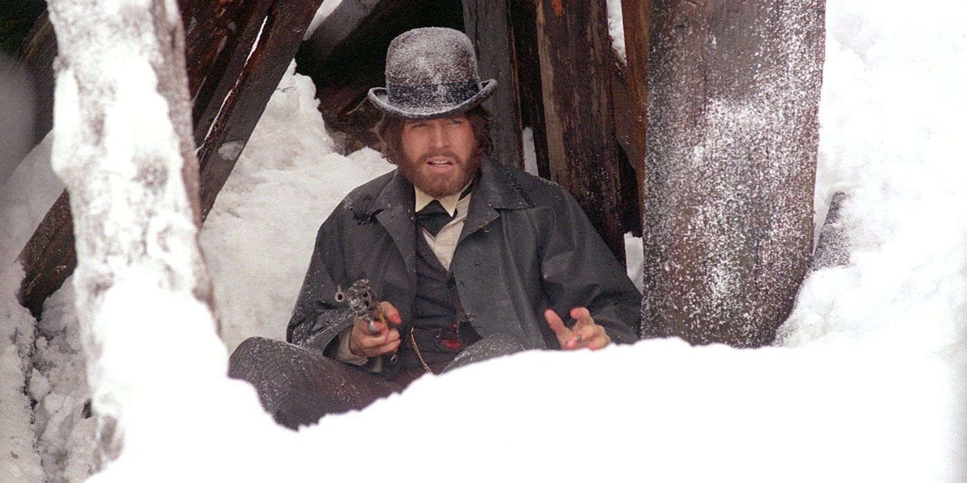 Warren Beatty as McCabe, holding a gun and bleeding in McCabe & Mrs. Miller 