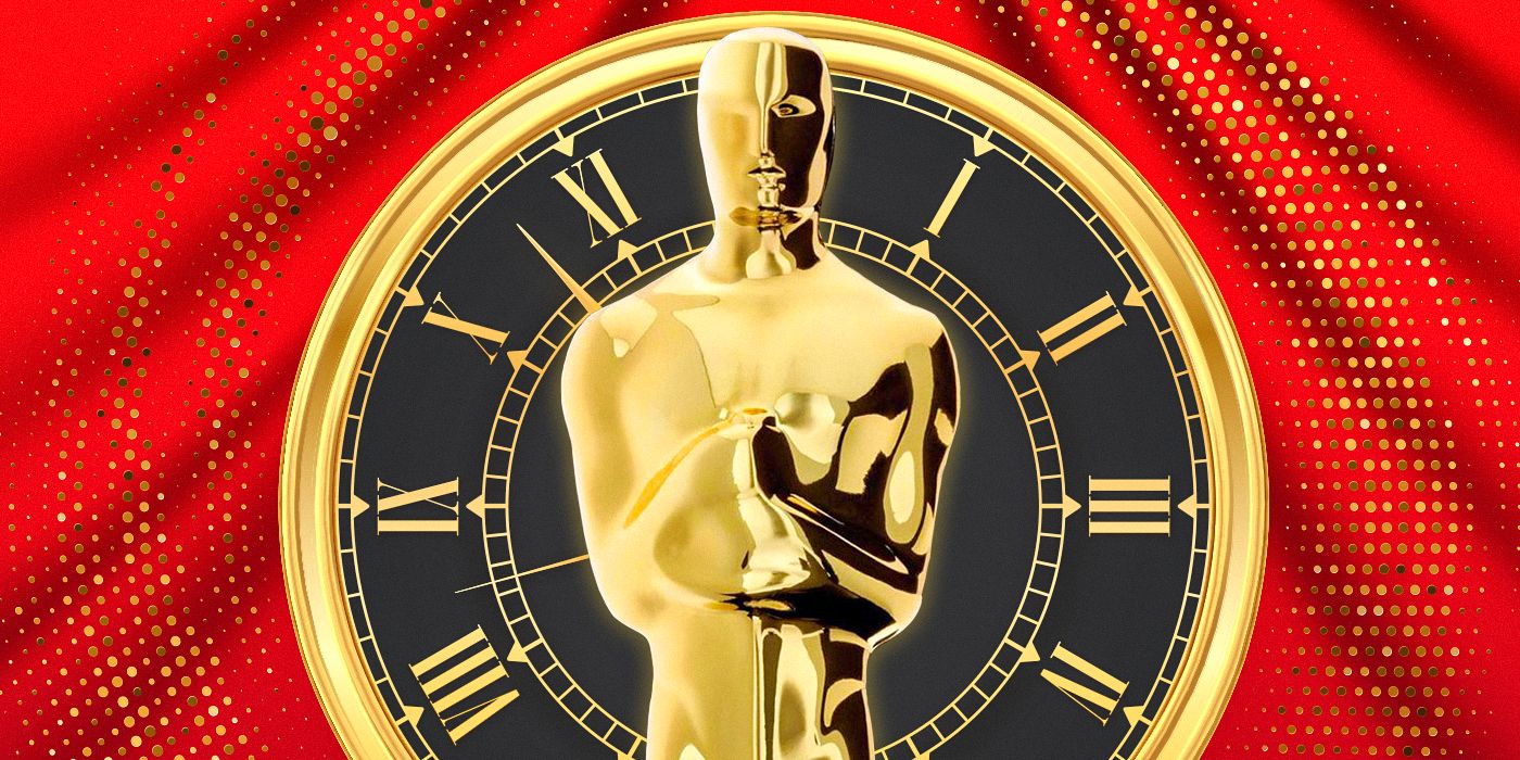 A picture of an Oscar statue in front of a clock and a red curtain.