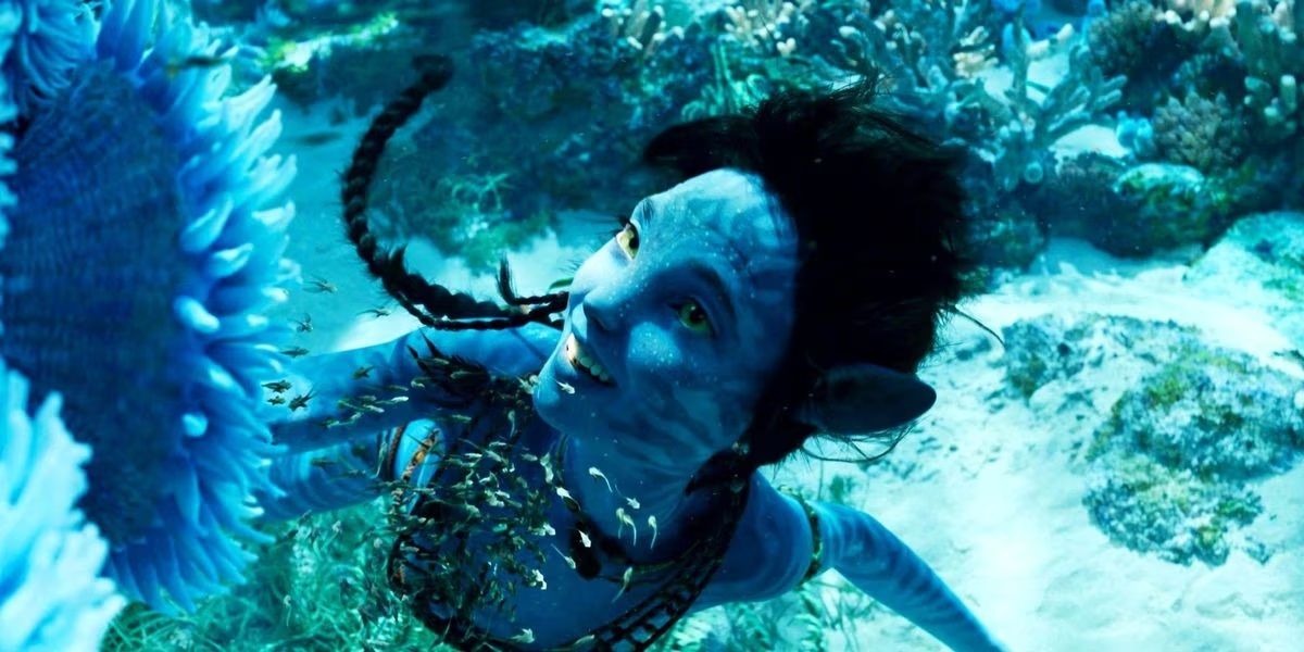 Kiri, played by Sigourney Weaver, swims in the reef in Avatar: The Way of Water