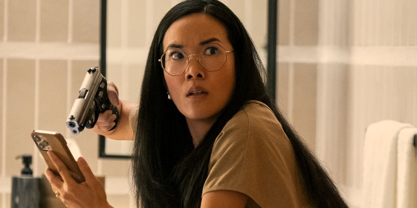 Ali Wong holding a gun to her iPhone as Amy Lau in Beef