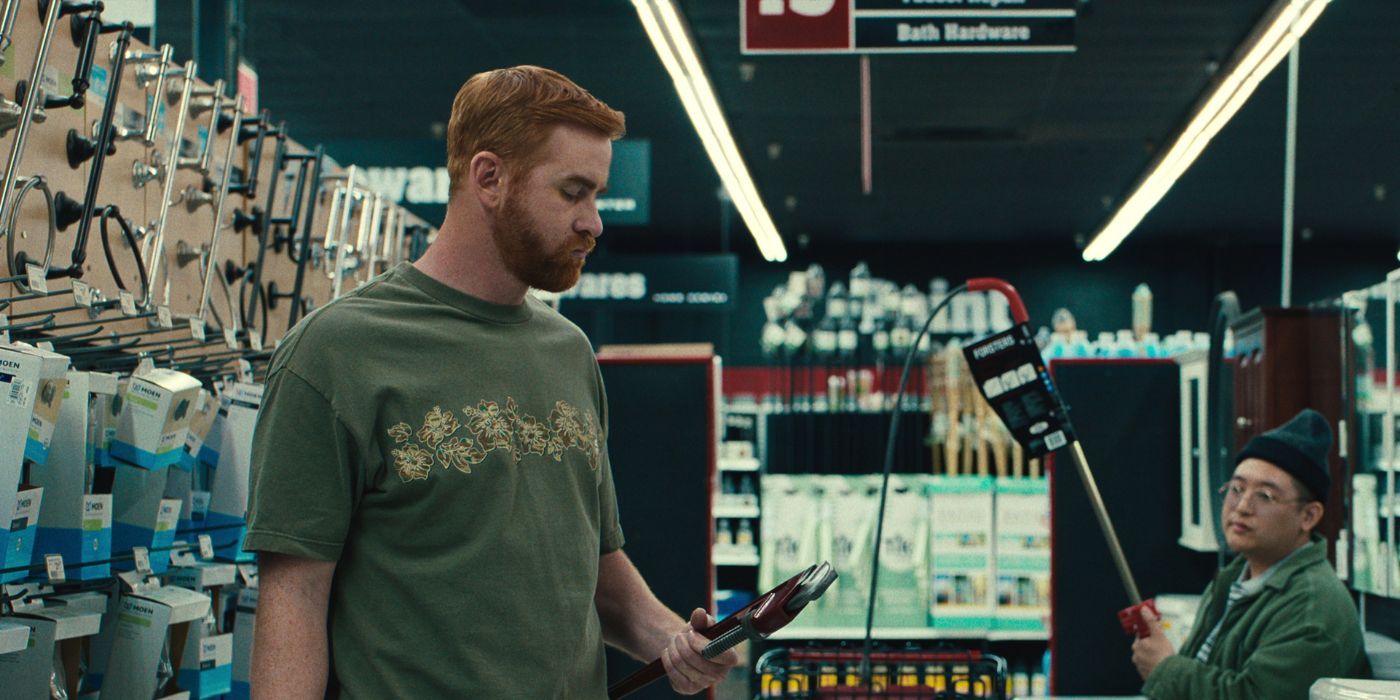 Andrew Santino holding a wrench in a store as Michael in Beef