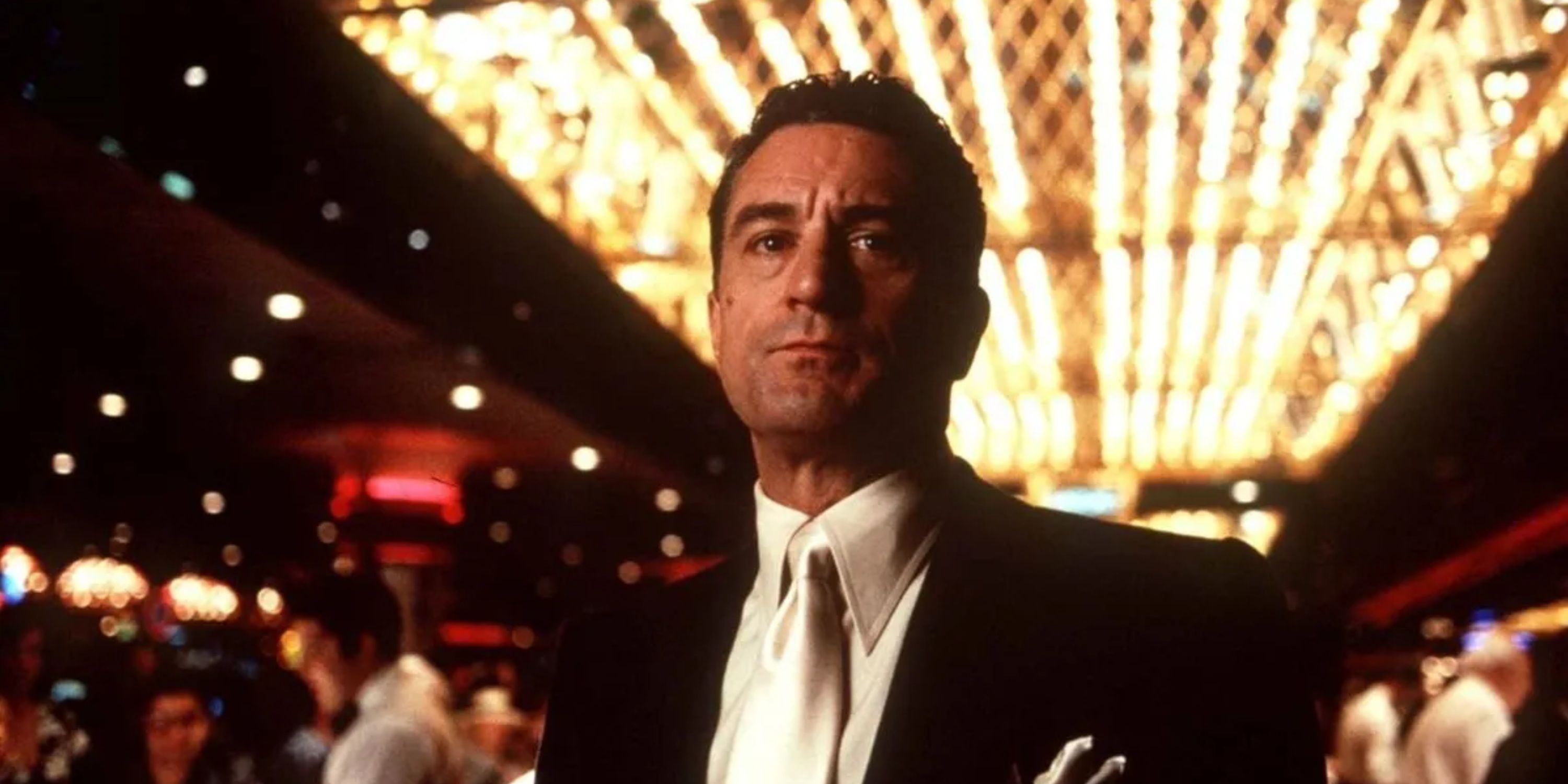 Man and black suit in brightly lit casino