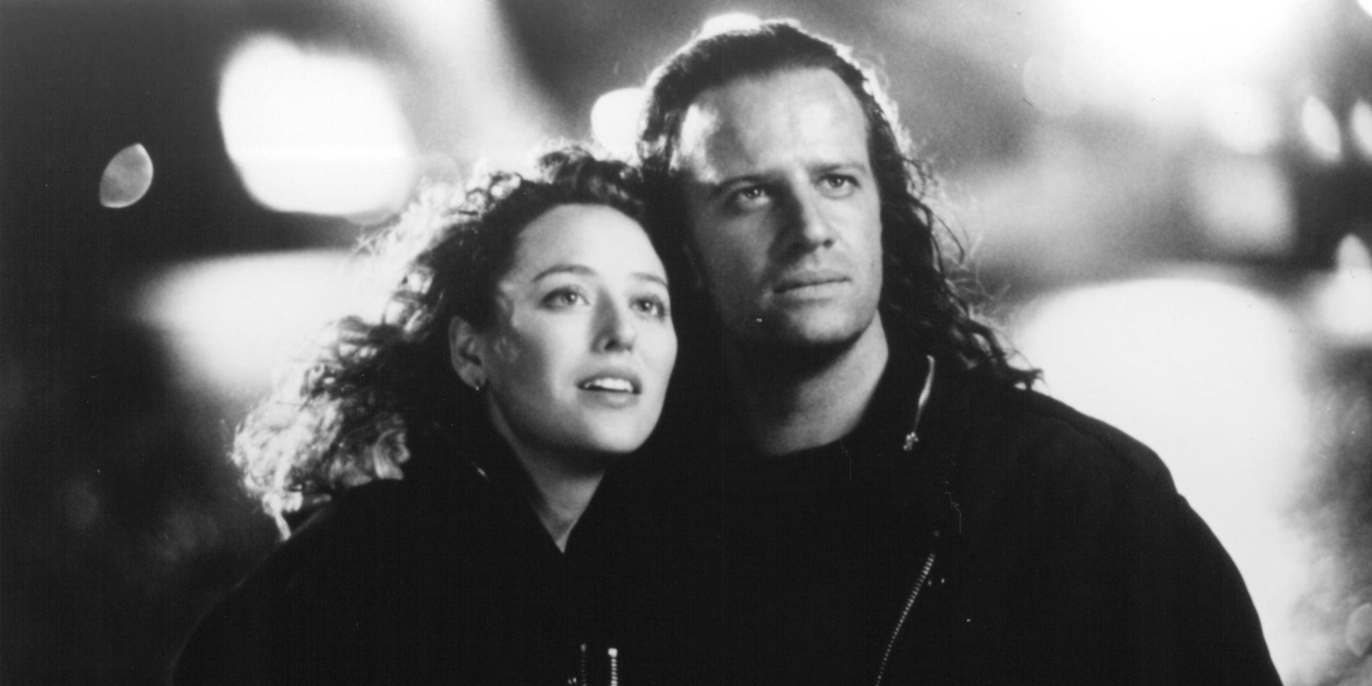 Christopher Lambert and Virginia Madsen leaning on each other in Highlander II: The Quickening