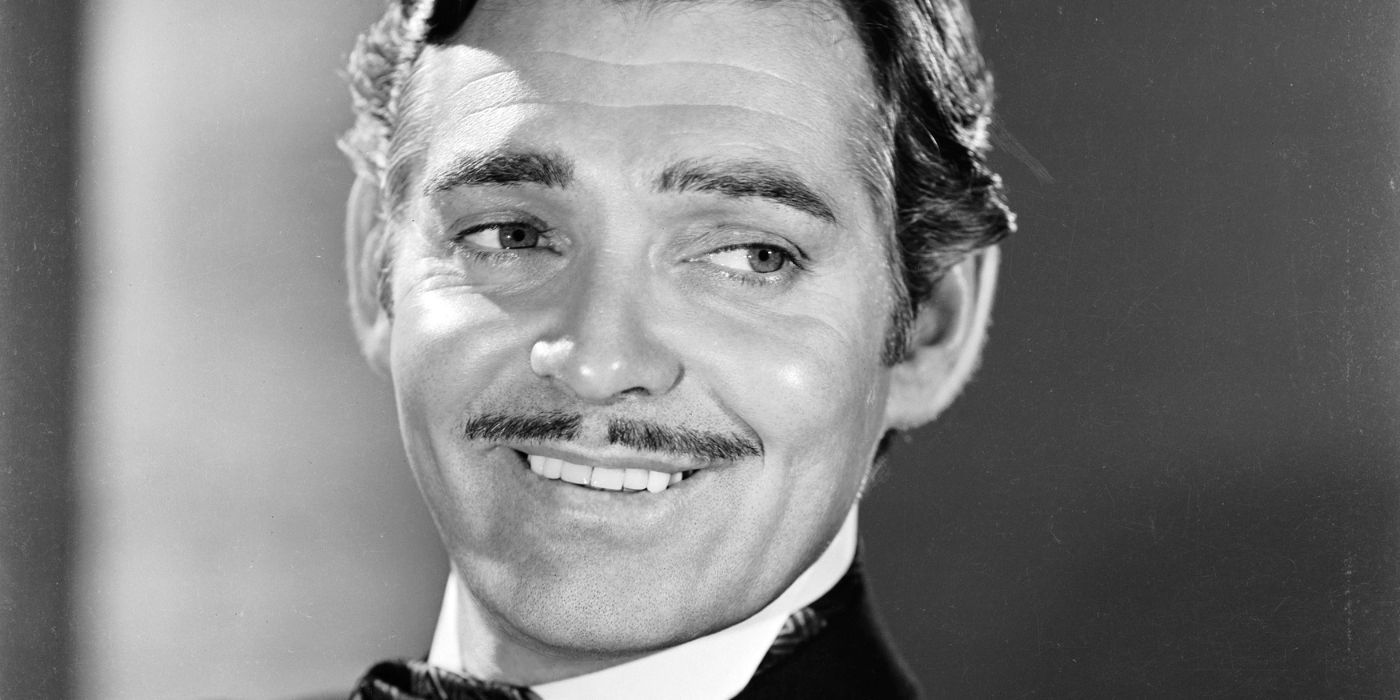 Portrait of Clark Gable smiling and looking to his left.