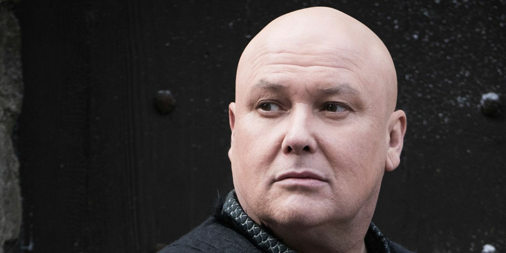 Conleth Hill as Lord Varys looking to the distance in Game of Thrones.