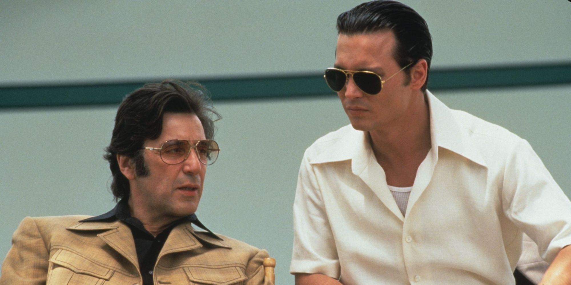 Al Pacino as Lefty sitting next to and speaking with Johnny Depp as Donnie Brasco in Donnie Brasco