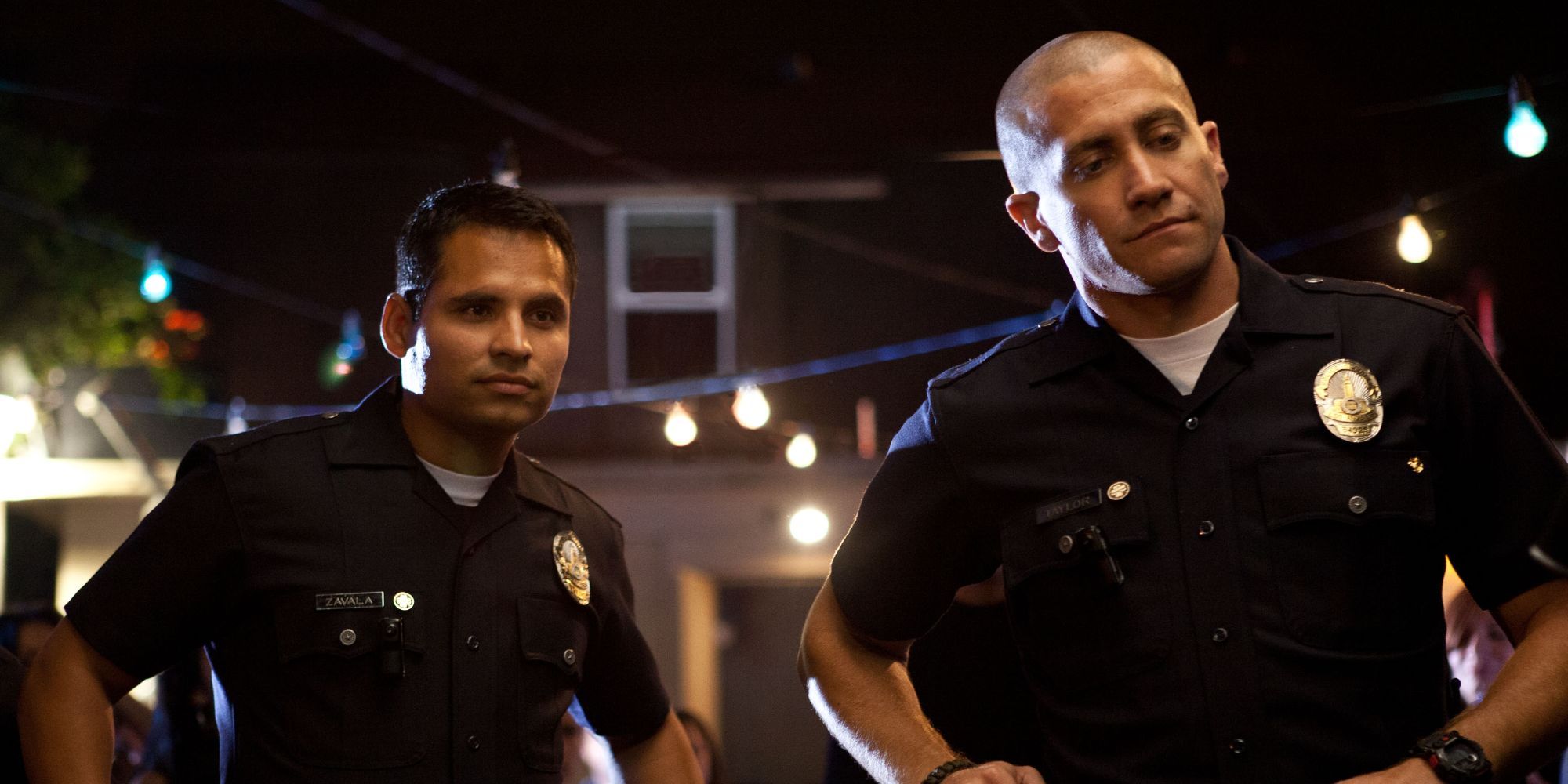 Michael Peña and Jake Gyllenhaal as Mike and Brian looking in the same direction End of Watch