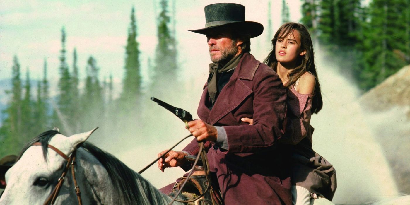 Clint Eastwood and Sydney Penny riding on a horse in Pale Rider