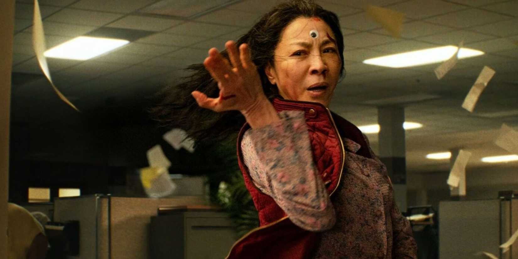 Evelyn, fighting while paper sheets fly around her in Everything Everywhere All at Once.
