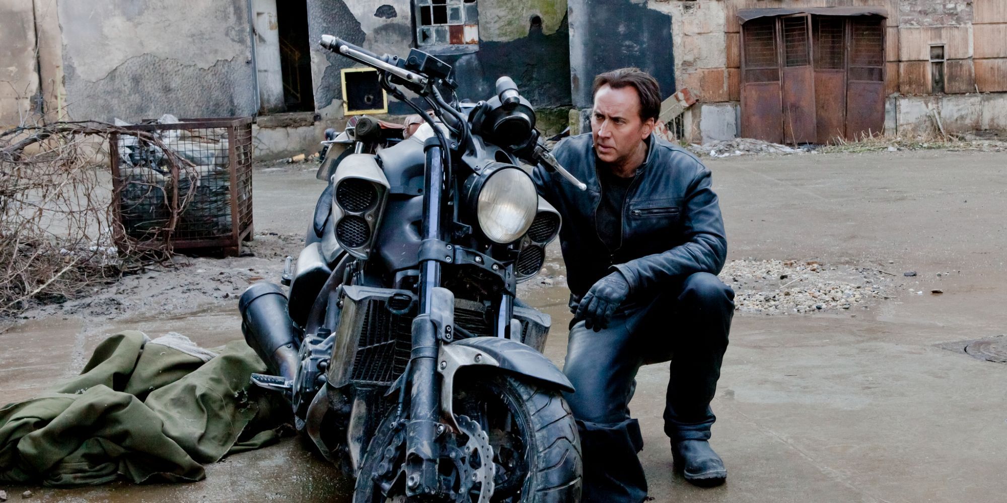 Nic Cage kneeling by a motorcycle in Ghost Rider: Spirit of Vengeance