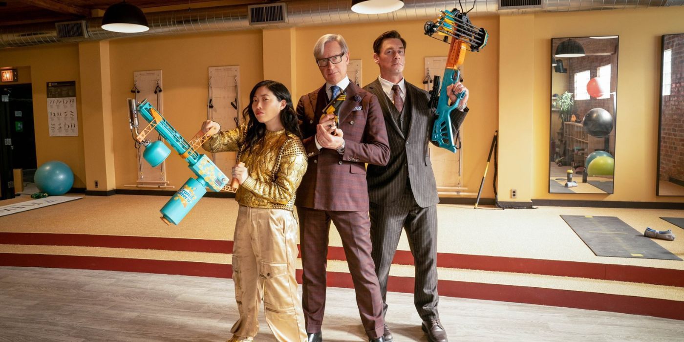 Awkwafina, Paul Feig, and John Cena wielding weapons on the set of Grand Death Lotto