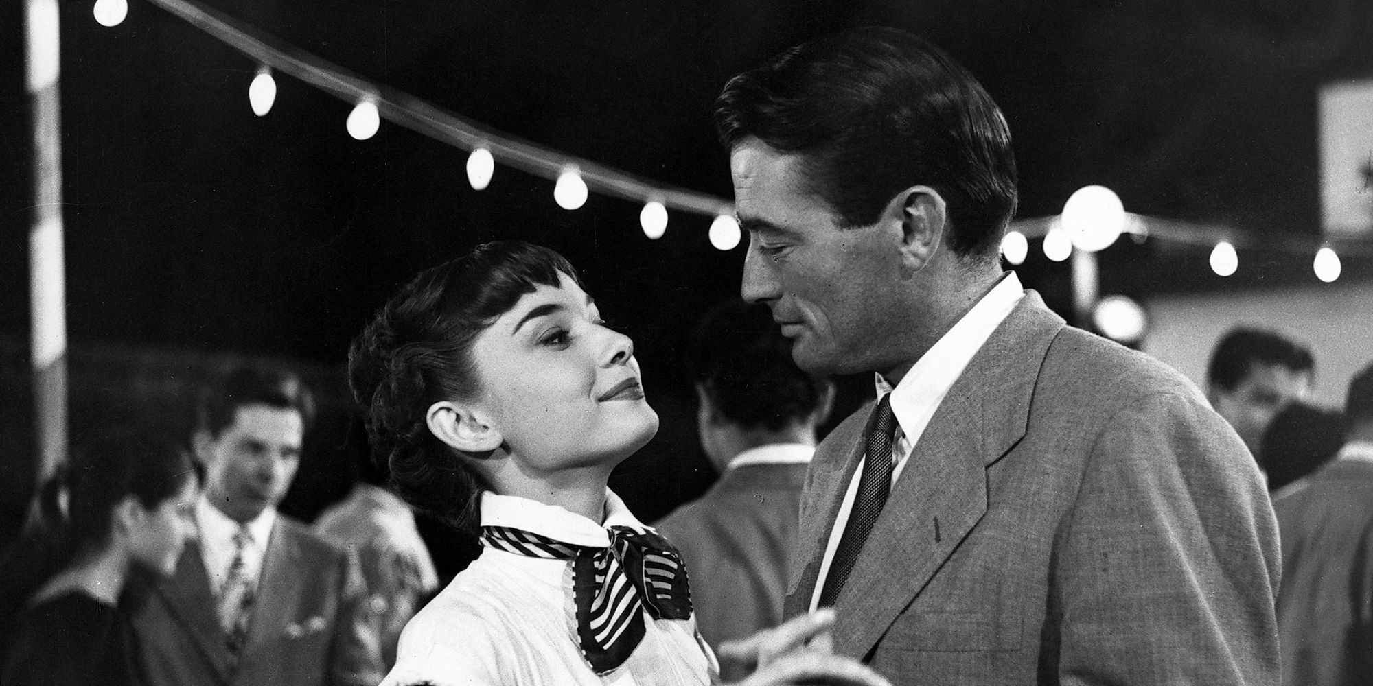 Gregory Peck and Audrey Hepburn looking at each other in Roman Holiday