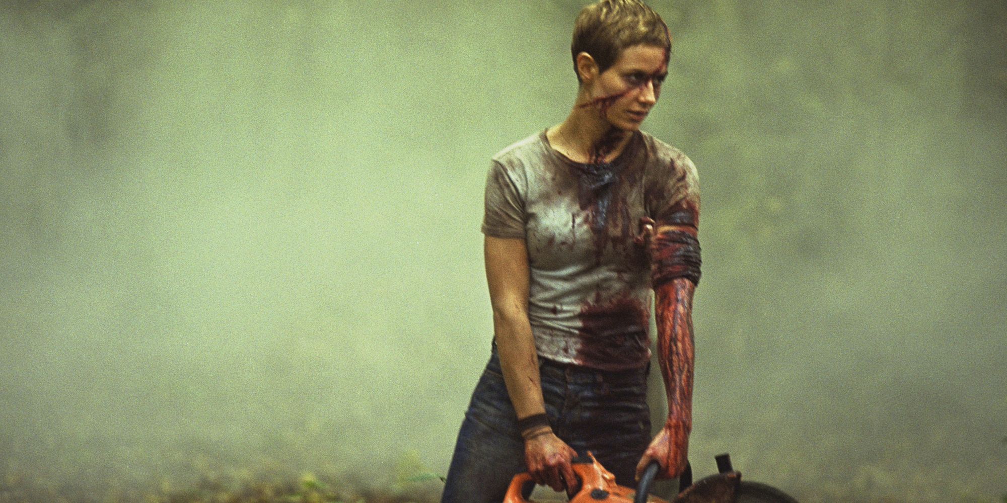 Still from 'High Tension': Marie (Cécile de France), covered in blood, holds a chainsaw. 