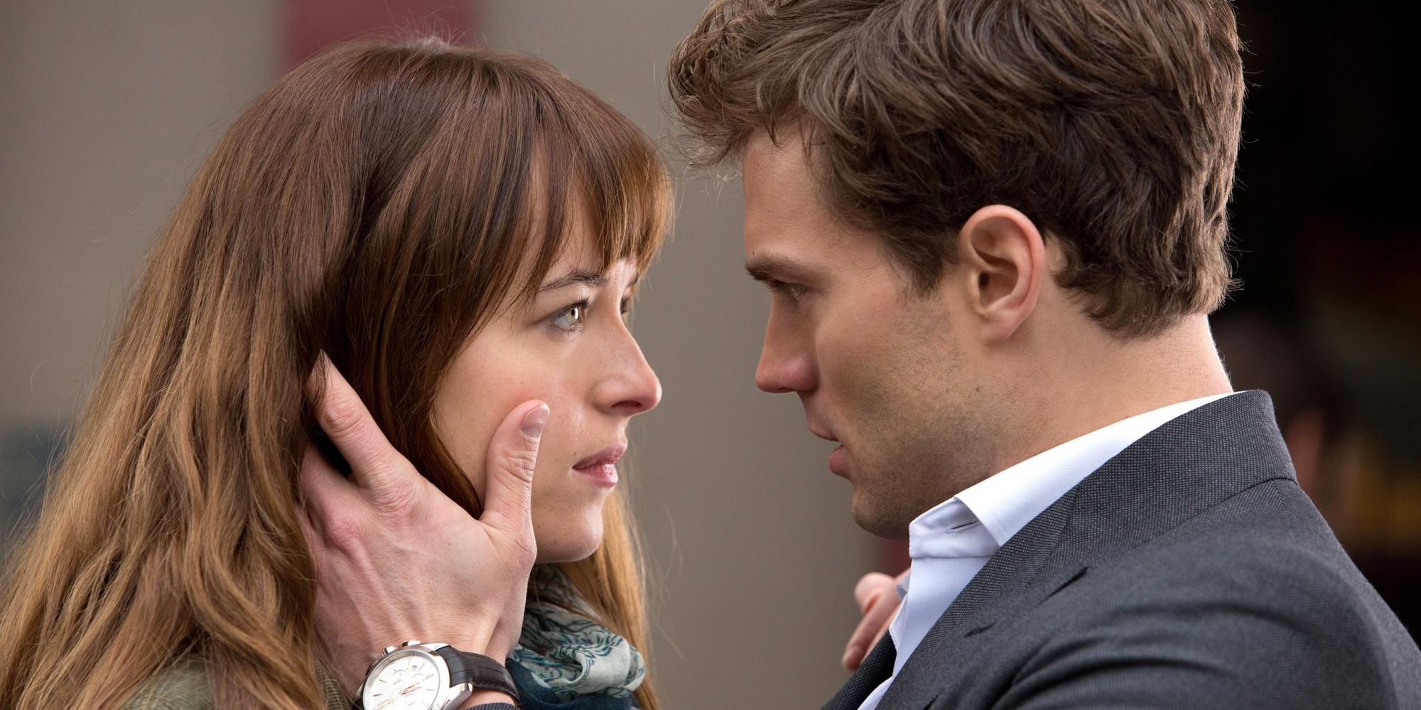 Jamie Dornan and Dakota Johnson looking at each other in Fifty Shades of Grey