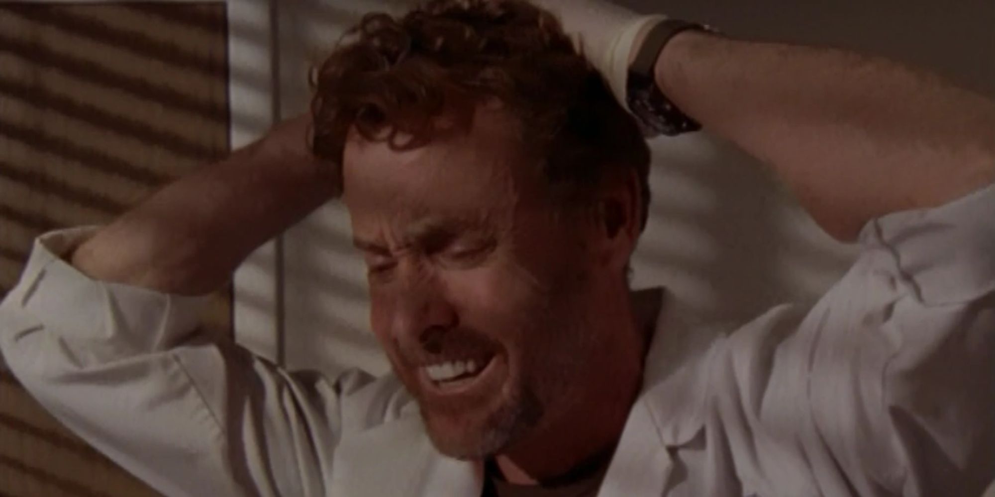 John C. McGinley with his hands on his head in Scrubs