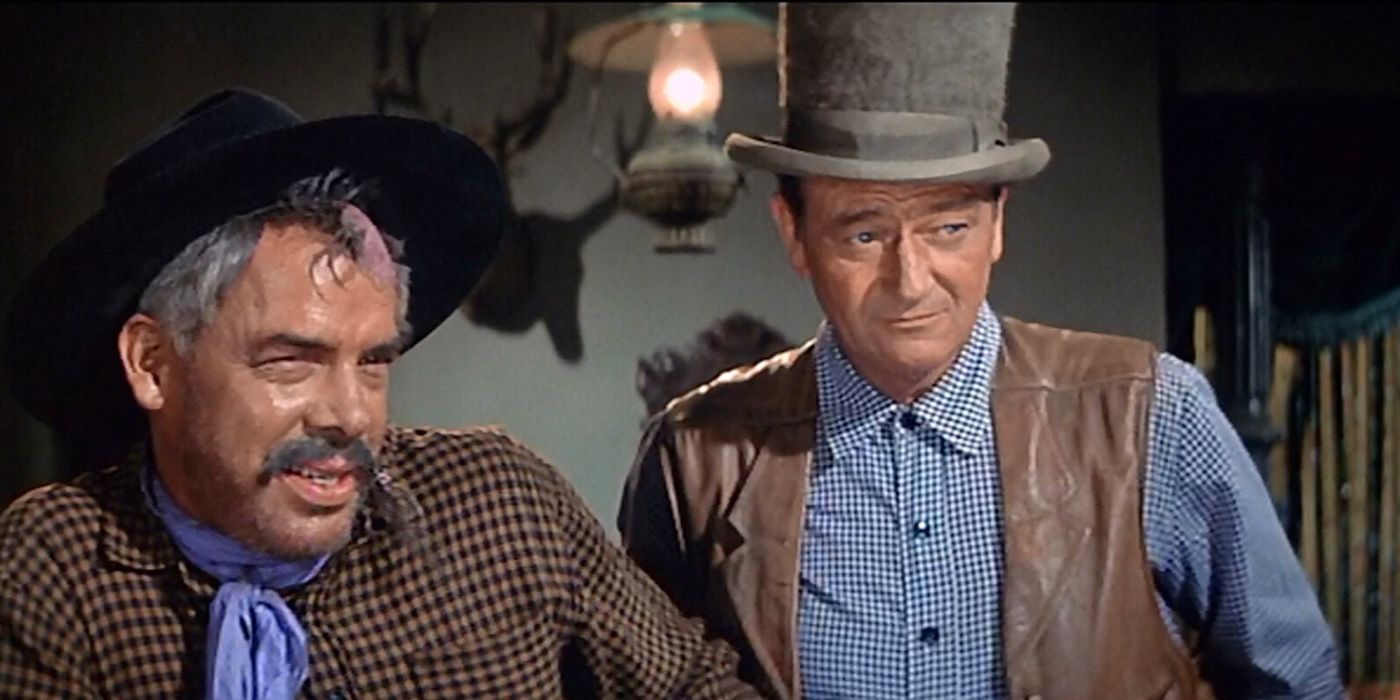 John Wayne and Lee Marvin standing next to each other in The Comancheros