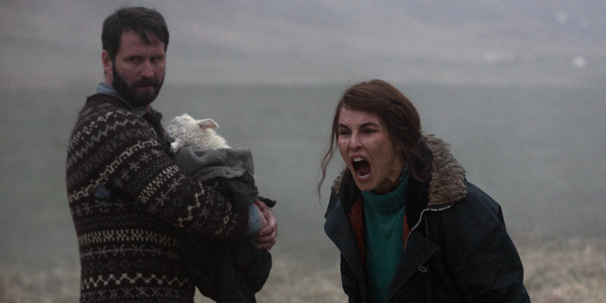 María (Rapace) screams at someone while Ingvar (Guðnason) nurtures their lamb child.