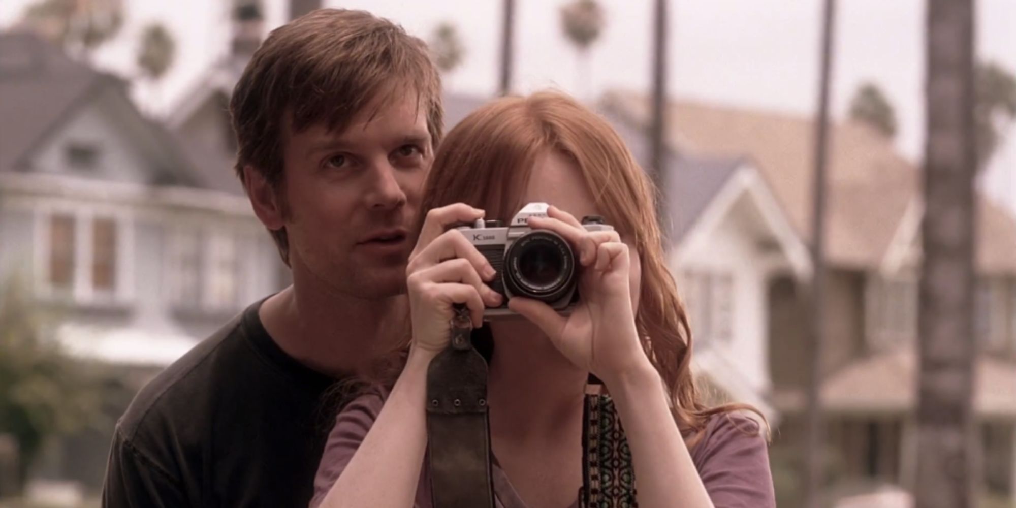 Lauren Ambrose holding a camera next to Peter Krause in Six Feet Under