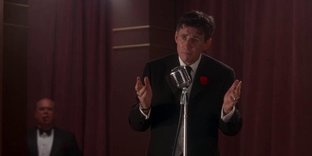 Gabriel Byrne standing at the mic in Mad Dog Time 