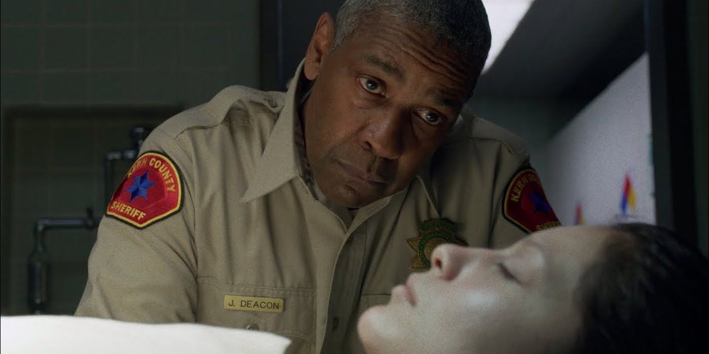 Denzel Washington as Deacon, looking sadly at a dead body in The Little Things