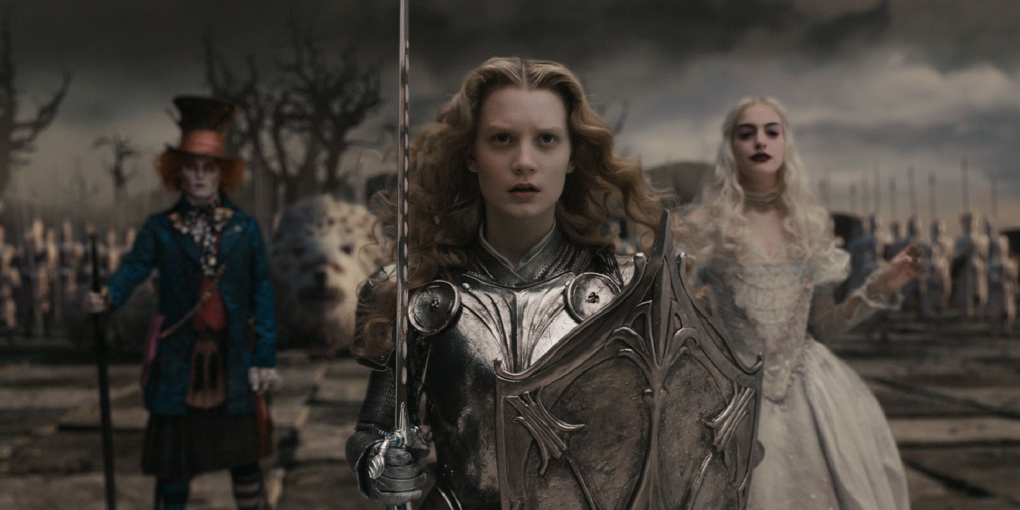 Alice holding a sword and wearing an armor while the Mad Hatter and the White Queen stand behind her in Alice in Wonderland