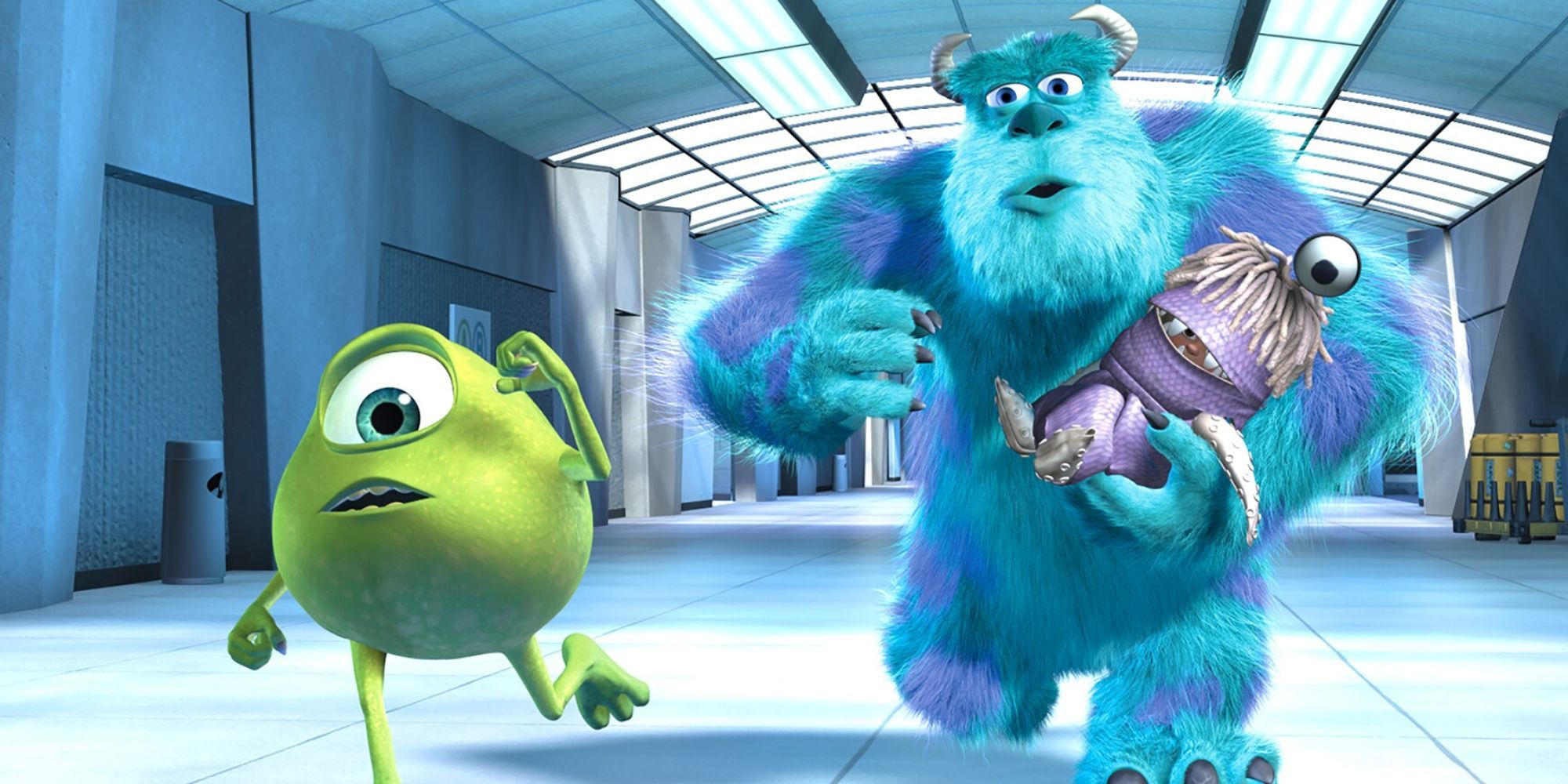 Mike (Billy Crystal) and Sulley (John Goodman) holding Boo (Mary Gibbs) in her monster costume and running down a hallway in Monsters Inc.