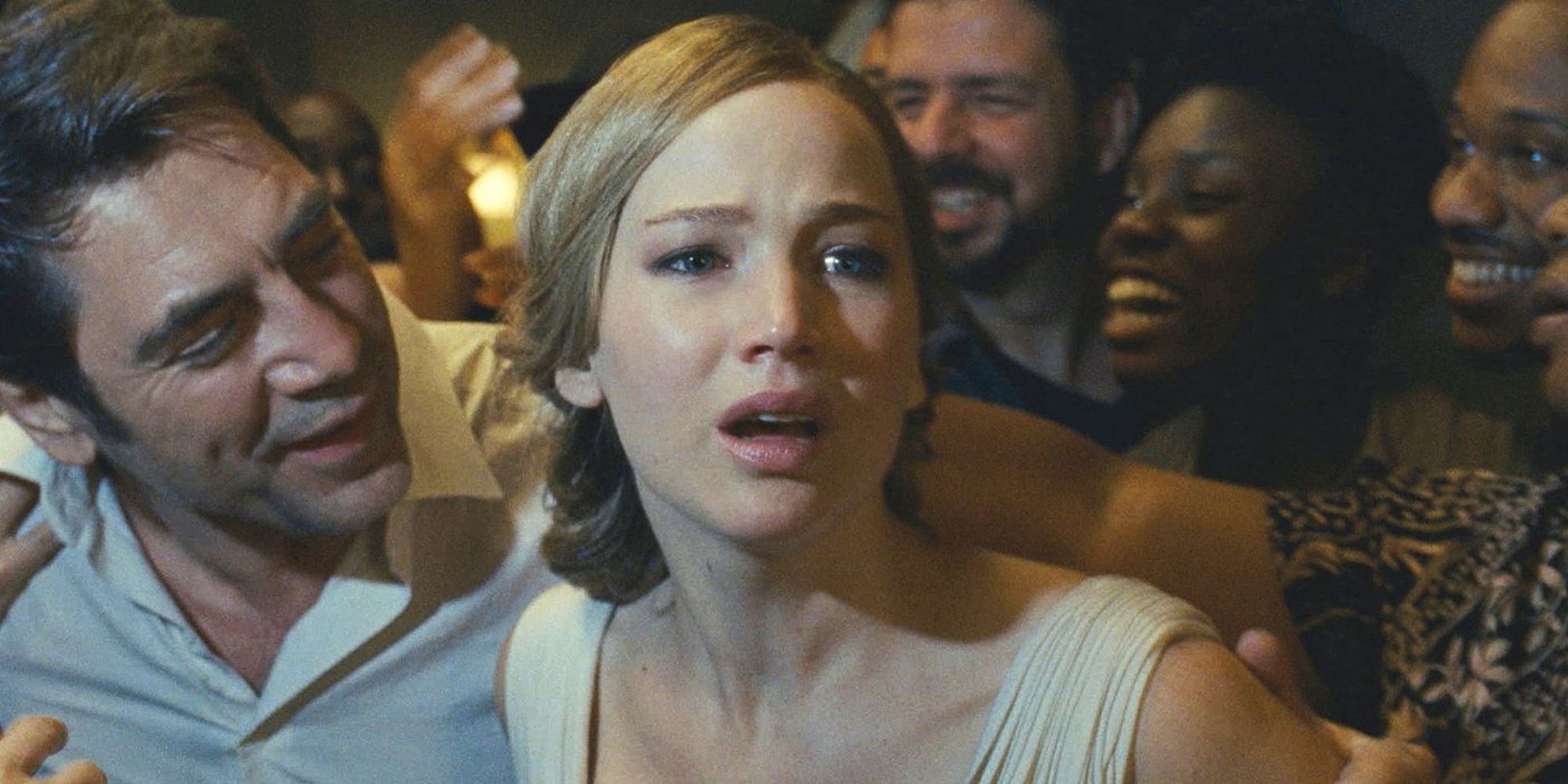 Javier Bardem guides Jennifer Lawrence through a crowd of strangers in mother!