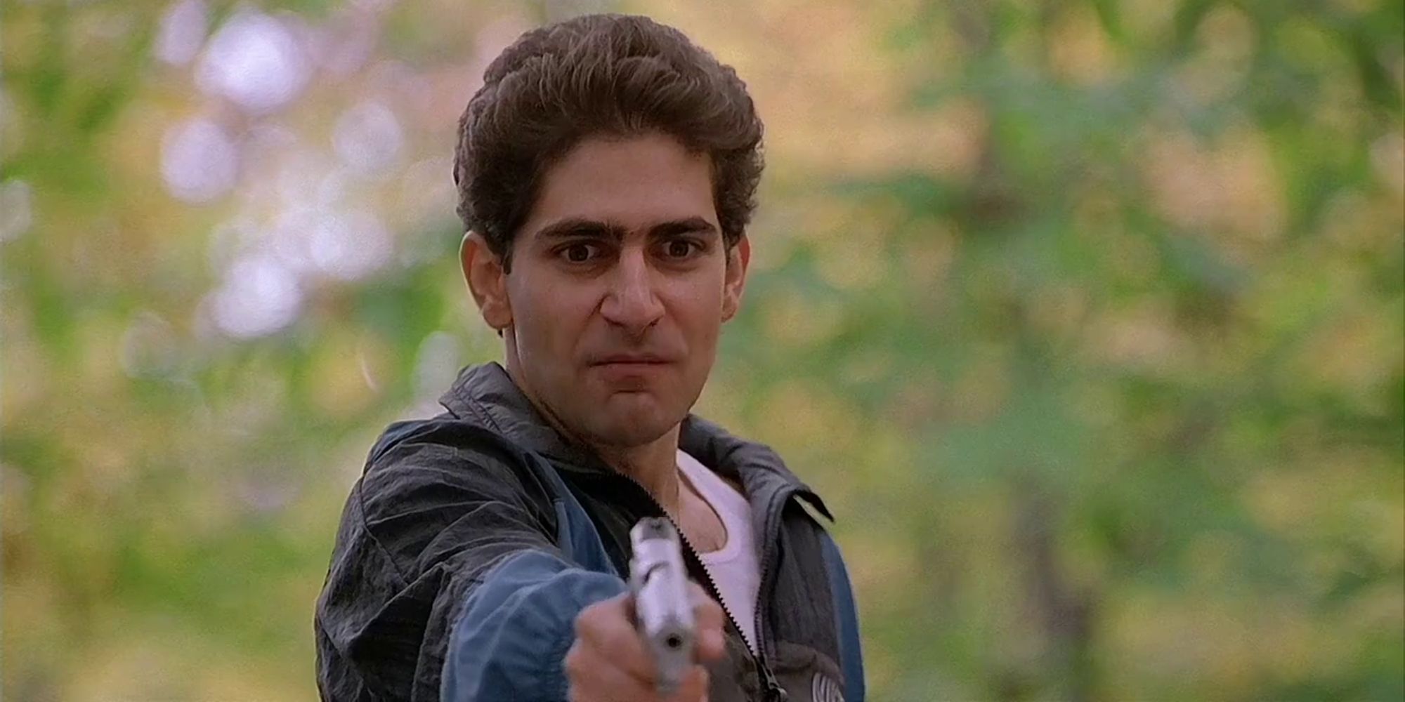 Christopher Moltisanti aiming a gun at someone off-camera in the Sopranos