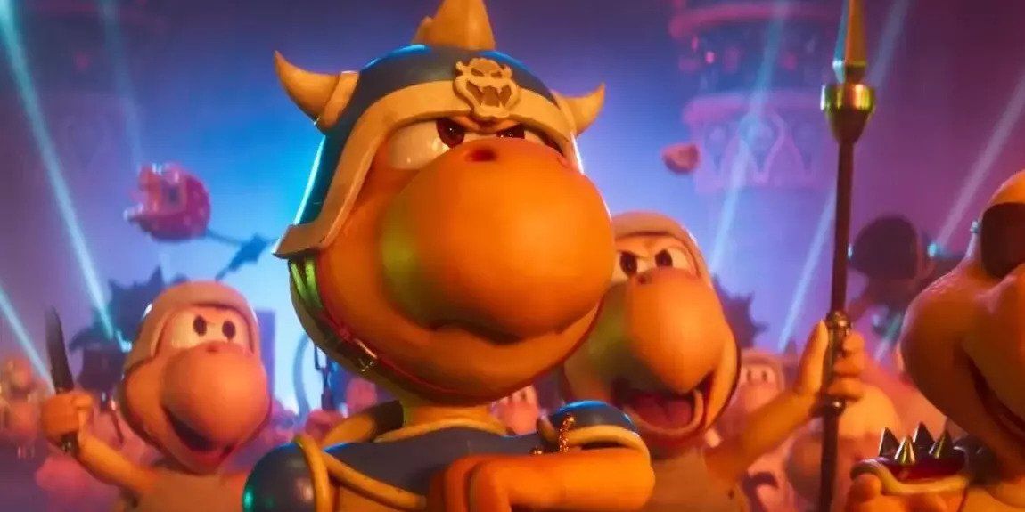 A still from The Super Mario Bros. Movie featuring the Koopa General, voiced by Scott Menville, in the middle of doing a military salute while surrounded by other members of Bowser's army.